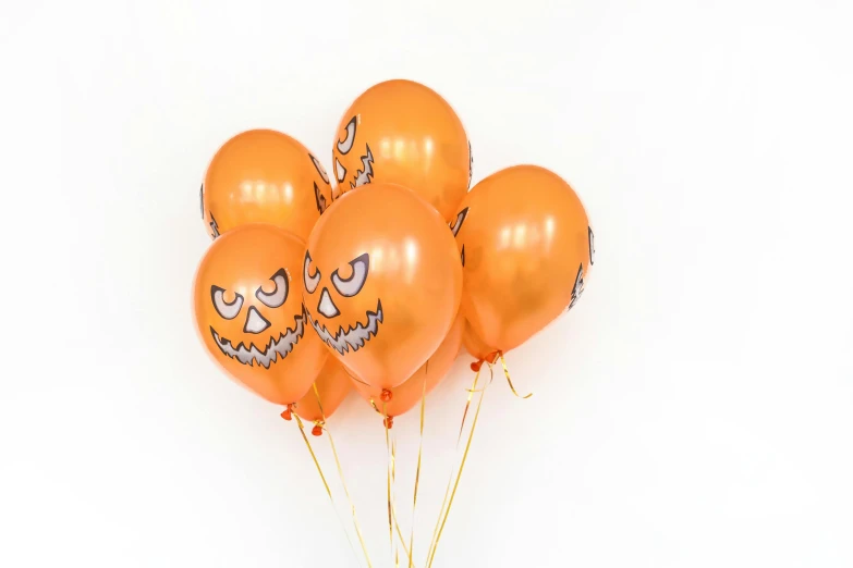 a bunch of orange balloons with faces on them, detailed product image, in a halloween style, clear [bronze] face, official product image