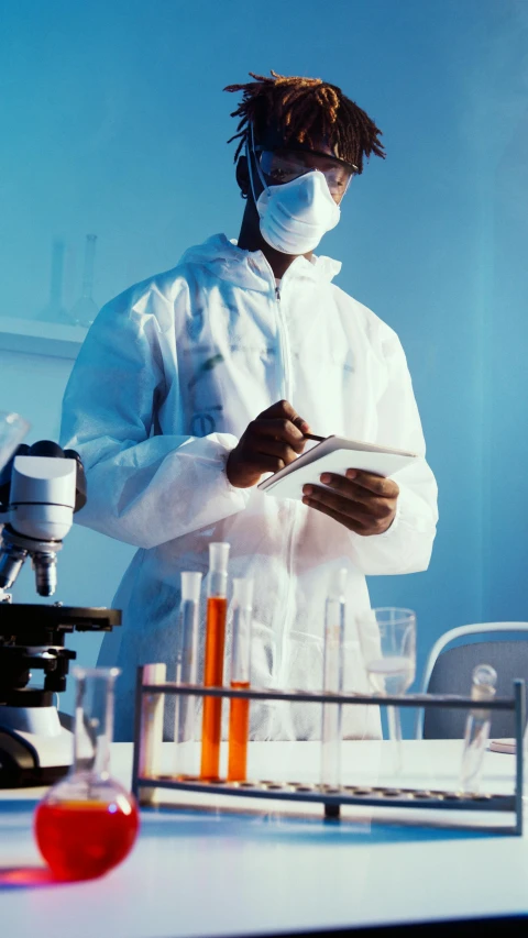 a man in a lab coat standing in front of a microscope, shutterstock, analytical art, hazmat suits, snapchat photo, schools, surgical gown and scrubs on