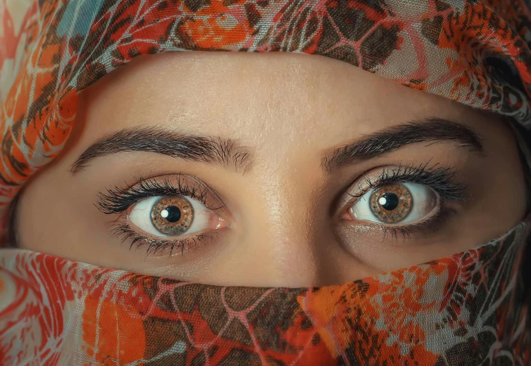 a close up of a person wearing a headscarf, trending on pexels, realistic symmetrical eyes, large bushy eyebrows, eyes). full body, orange pupils