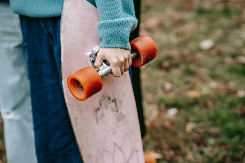a close up of a person holding a skateboard, by Emma Andijewska, pexels contest winner, cottagecore!! fitness body, 🦩🪐🐞👩🏻🦳, autumn season, 1 7 9 5