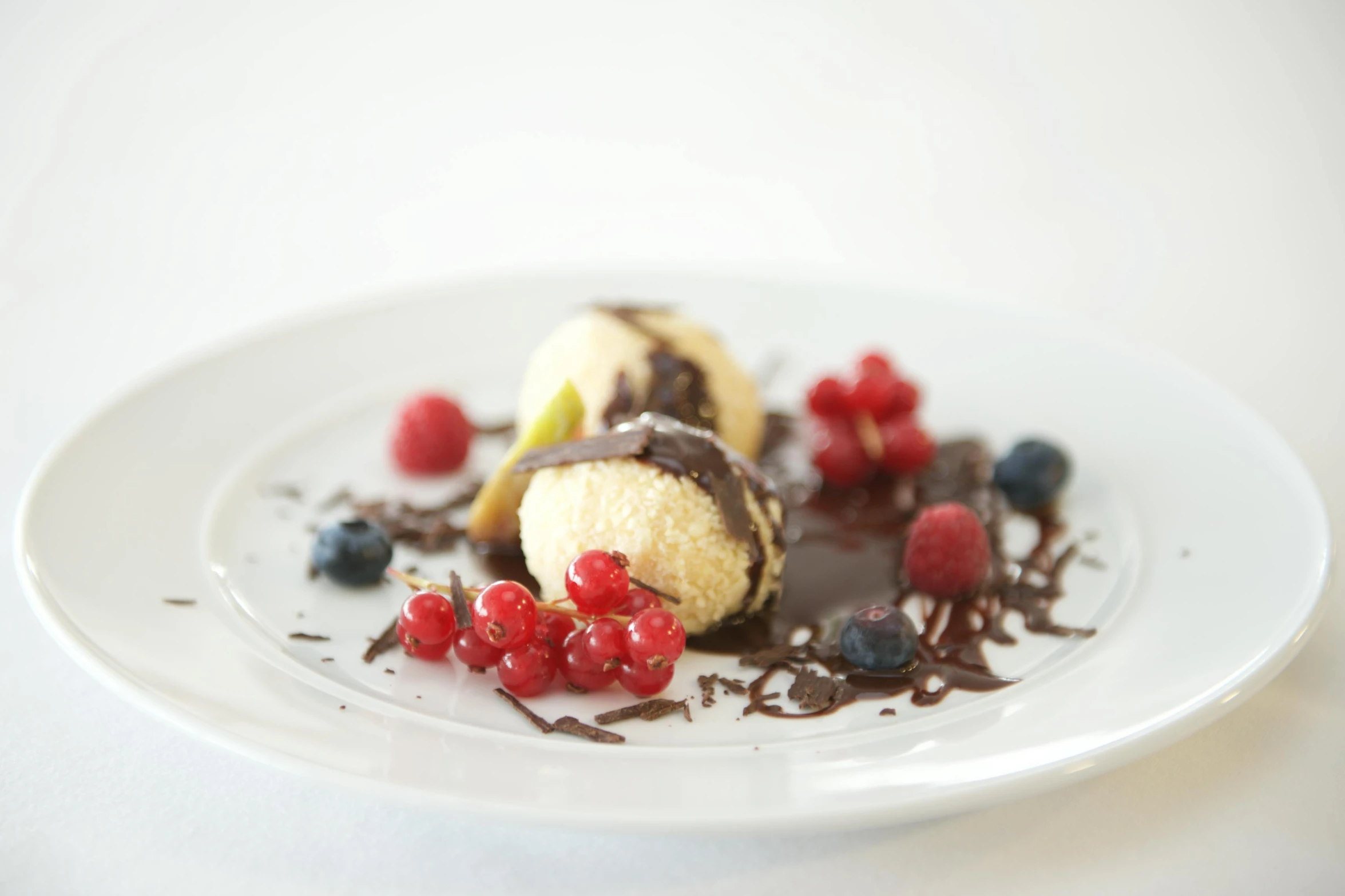 a close up of a plate of food on a table, berries, ice cream, chocolate, image