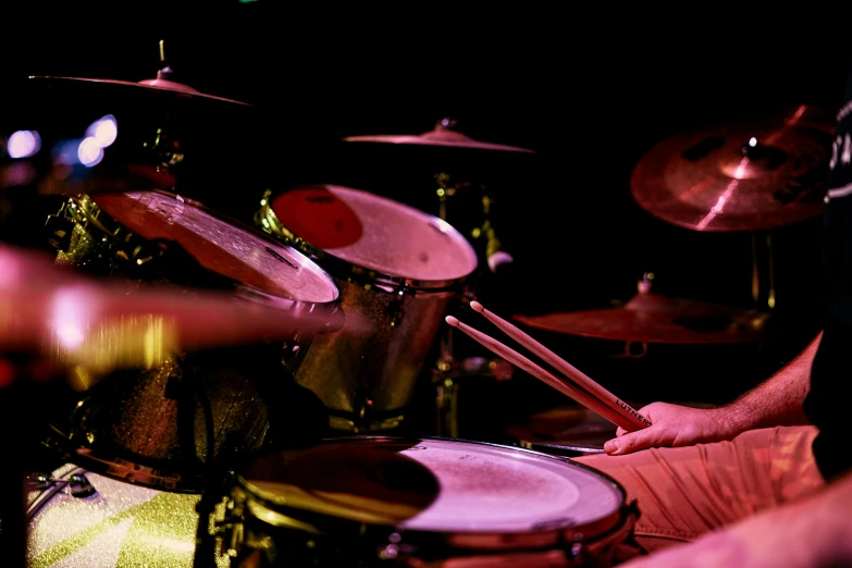 a close up of a person playing drums, an album cover, by Matt Stewart, pexels, panoramic, fan favorite, pink, king crimson