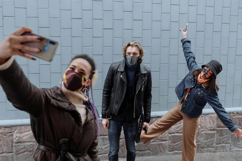 a group of people standing next to each other on a sidewalk, graffiti, face covers half of the frame, avatar image, andrei riabovitchevy, selfie photo