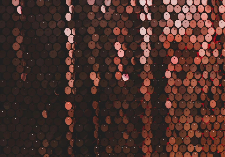 a fire hydrant sitting in front of a wall covered in circles, an album cover, by Attila Meszlenyi, pexels contest winner, pointillism, beaded curtains, brown and pink color scheme, evening lights, black and terracotta