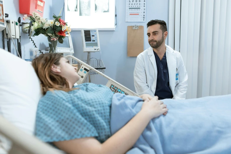 a man standing next to a woman in a hospital bed, profile image, charli bowater, production photo, realistic »