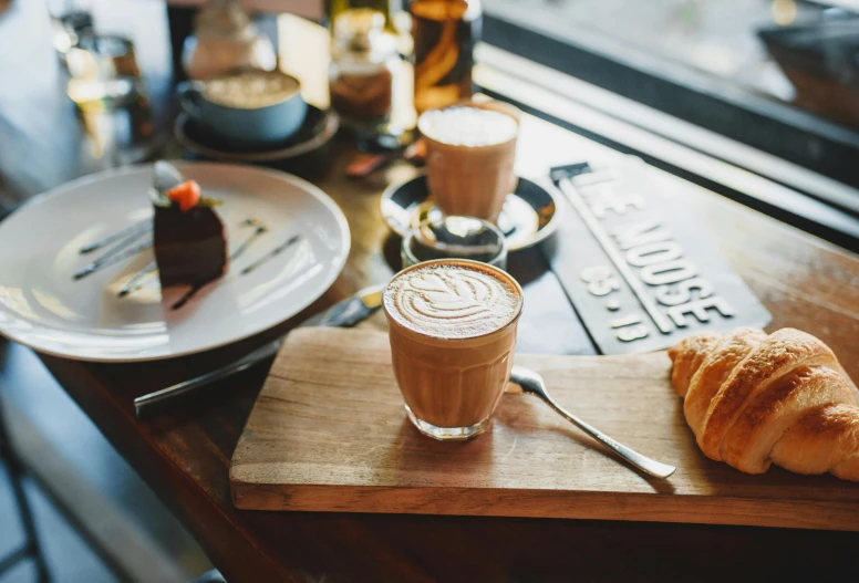 a table topped with plates of food and a cup of coffee, aussie baristas, profile image