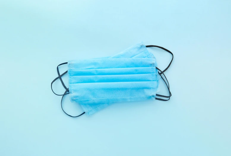 a blue surgical mask on a white background, an album cover, pexels, plasticien, light blue background, intubation equipment, 1x, rectangular