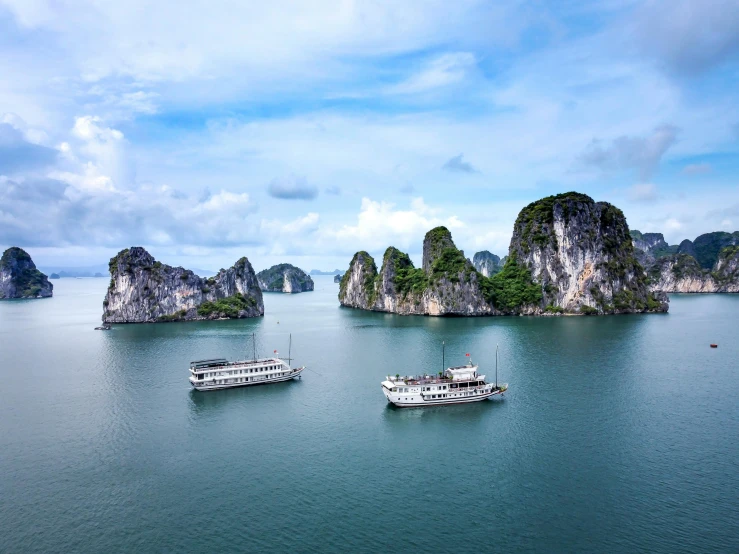 a couple of boats floating on top of a body of water, a picture, bao phan, limestone, 1 petapixel image