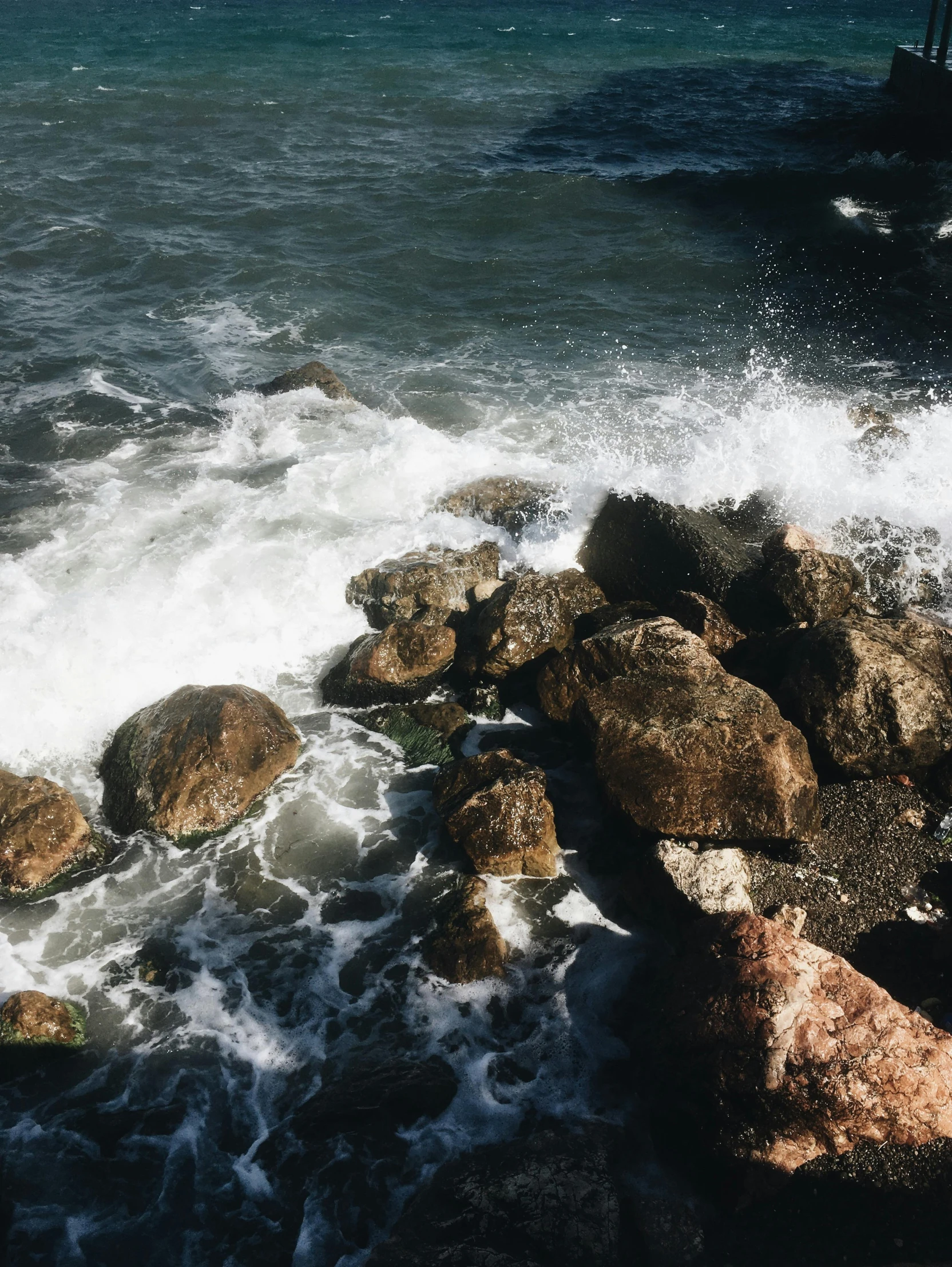 a man standing on top of a rock next to the ocean, rushing water, naples, instagram picture, full frame image