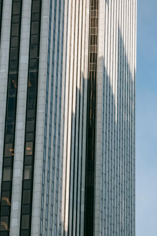 a clock that is on the side of a building, tall skyscraper, afternoon light, viewed from afar, a pair of ribbed