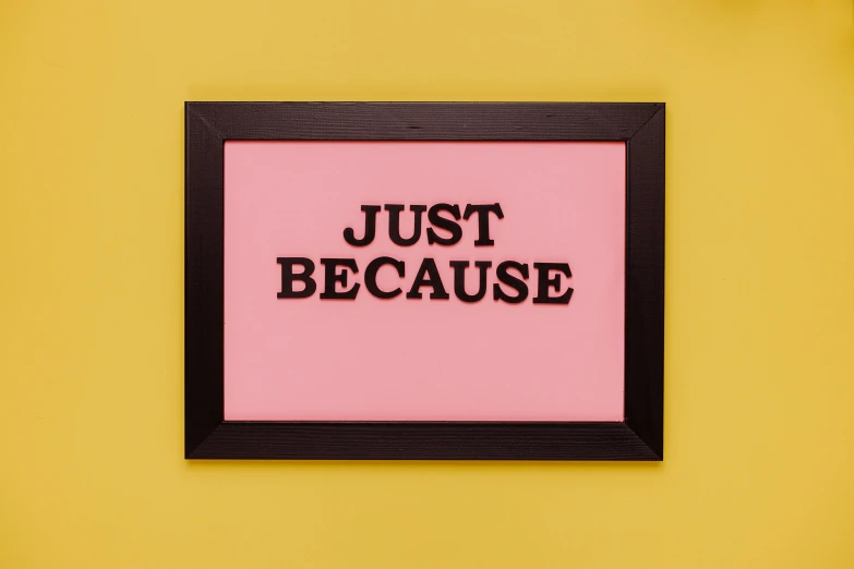 a picture frame with the words just because written on it, by Julia Pishtar, unsplash, pink and yellow, julian opie, three quarter view, wall art