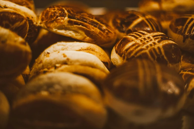 a close up of a bunch of baked goods, by Alejandro Obregón, pexels contest winner, baroque, warm shading, colombian, rounded shapes, softly lit