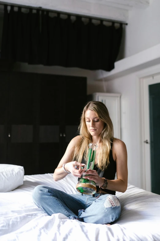 a woman sitting on a bed reading a book, process art, smoking a magical bong, sydney hanson, resort, profile image