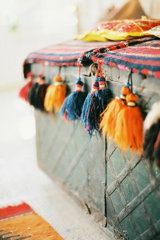 a trunk that has a bunch of tassels on it, trending on unsplash, arab inspired, ornaments, portra 8 0 0 ”, colorful”