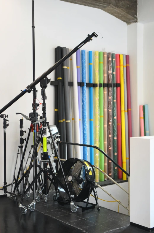 a camera that is on a tripod in a room, art materials, vinyl material, lightshafts, cyan photographic backdrop