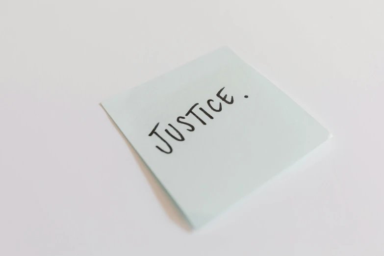 a piece of paper with the word justice written on it, unsplash, on a pale background, profile image, background image, protest