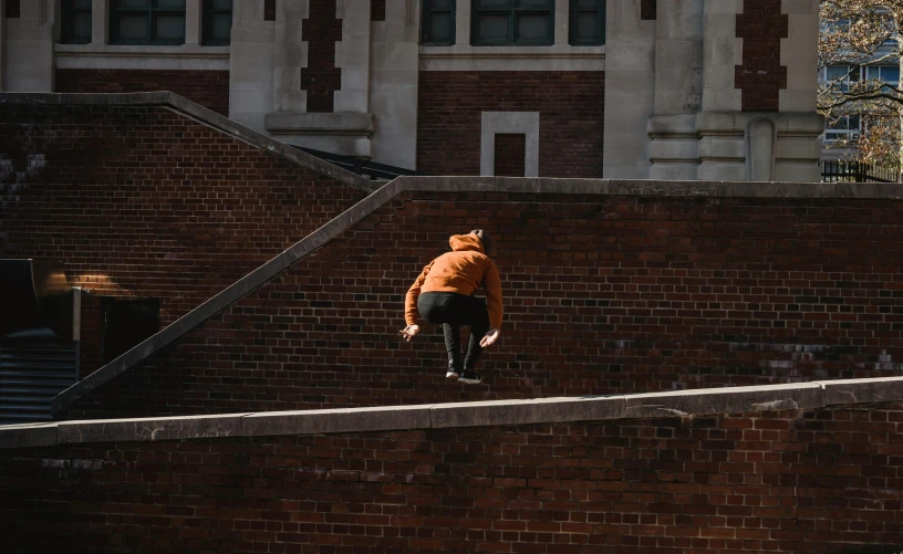 a man riding a skateboard up the side of a brick wall, pexels contest winner, happening, orange roof, trying to study, stairways, cinematic outfit photo