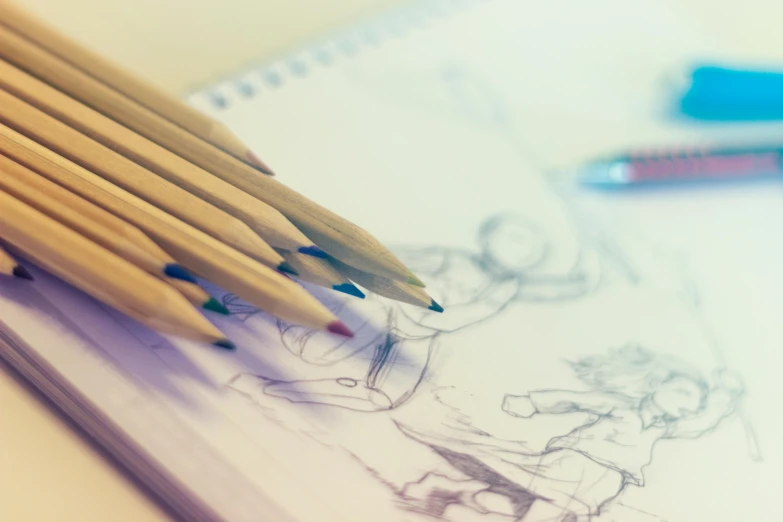 a bunch of pencils sitting on top of a piece of paper, a manga drawing, Artstation, academic art, fan favorite, james jean soft light 4 k, image of random arts, drawing pictures on a notebook