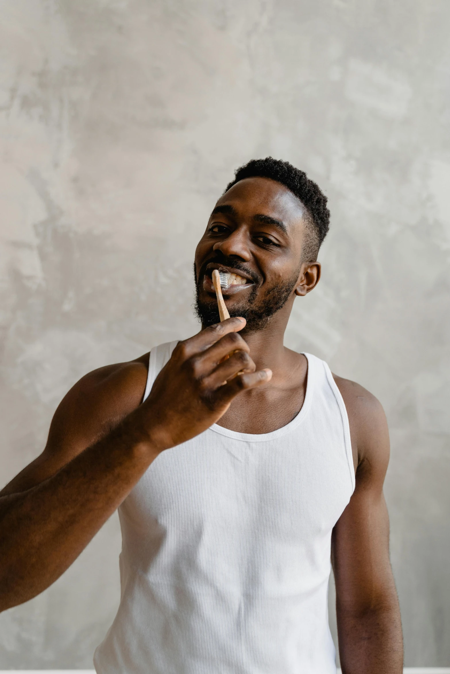 a man brushing his teeth with a toothbrush, pexels contest winner, renaissance, wearing tanktop, man is with black skin, soft smoke, satisfied pose