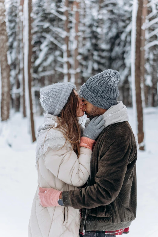 a man and woman standing next to each other in the snow, pexels contest winner, romanticism, kissing together cutely, 🚿🗝📝, profile image, beanie