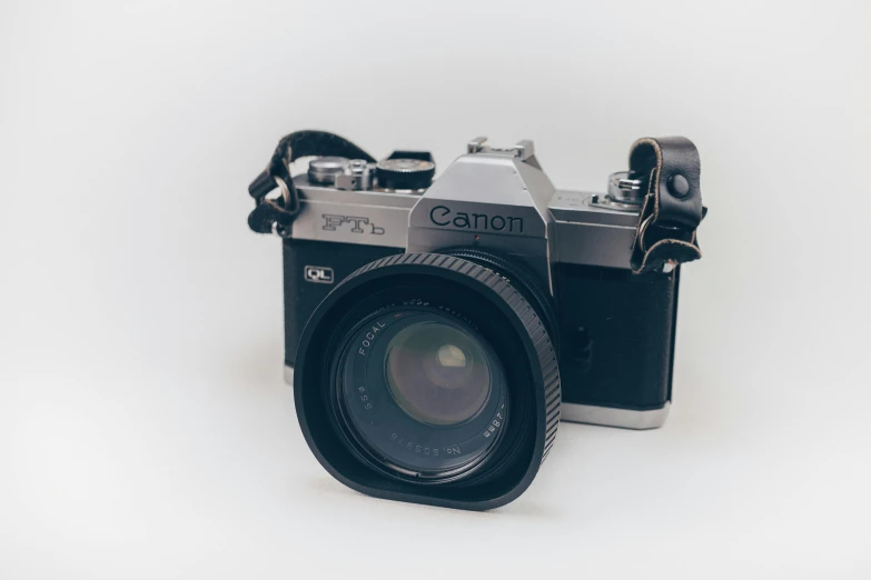 a close up of a camera on a white surface, by Carey Morris, unsplash contest winner, canon a1, camera on the ground, photo realistic style, on a pale background