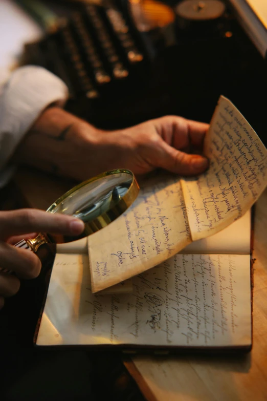 a person holding a magnifying glass over a piece of paper, an album cover, by Jakob Emanuel Handmann, unsplash, romanticism, with some hand written letters, victorian alchemists, slide show, on ship