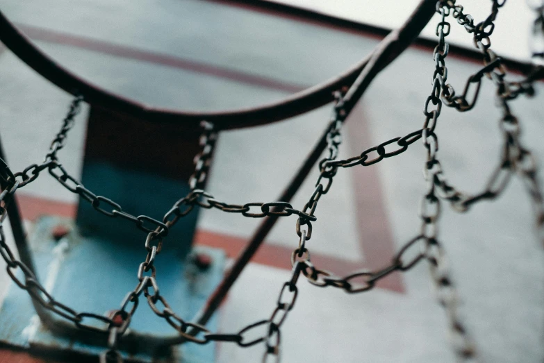 a basketball hoop with chains hanging from it, unsplash, subtle detailing, sitting down, ((chains)), interconnected