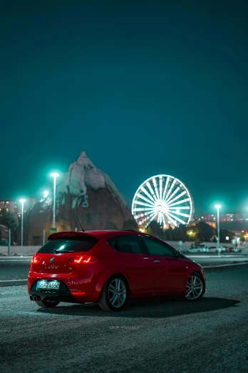 a red car parked in front of a ferris wheel, half rear lighting, near the sea, alfa romeo project car, high quality photo