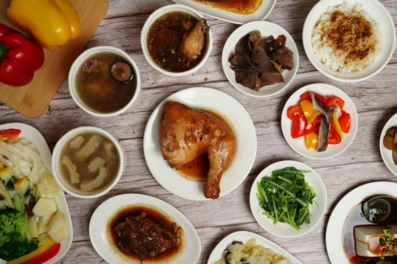 a number of plates of food on a table, unsplash, dau-al-set, chicken, hong kong, brown gravy, background image