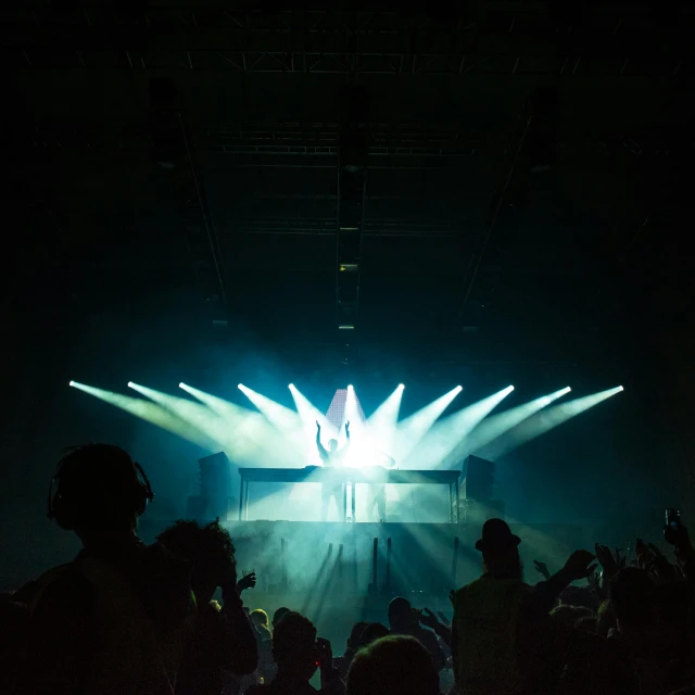 a group of people standing in front of a stage, pexels contest winner, light and space, college party, flume, music being played, from the distance