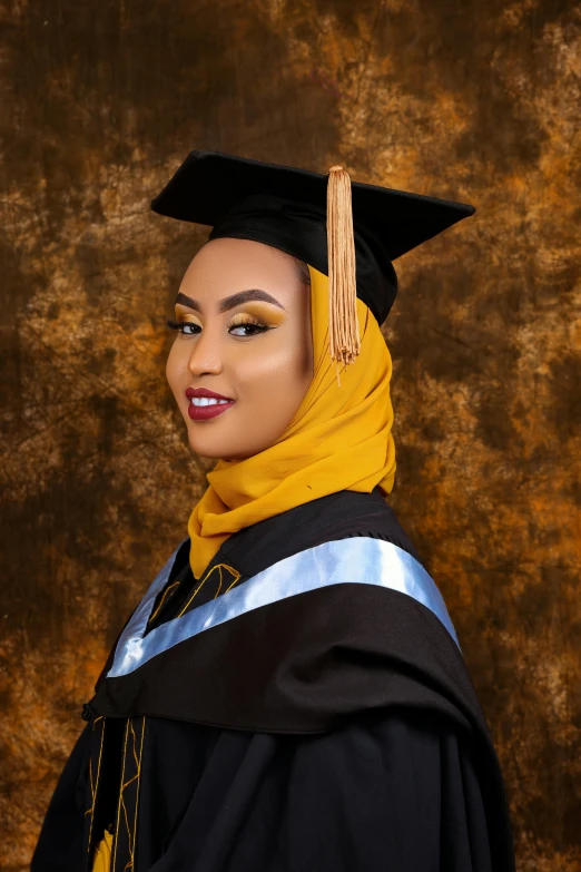 a woman wearing a graduation cap and gown, by Ingrida Kadaka, african ameera al taweel, with professional makeup, brown robes, ((portrait))