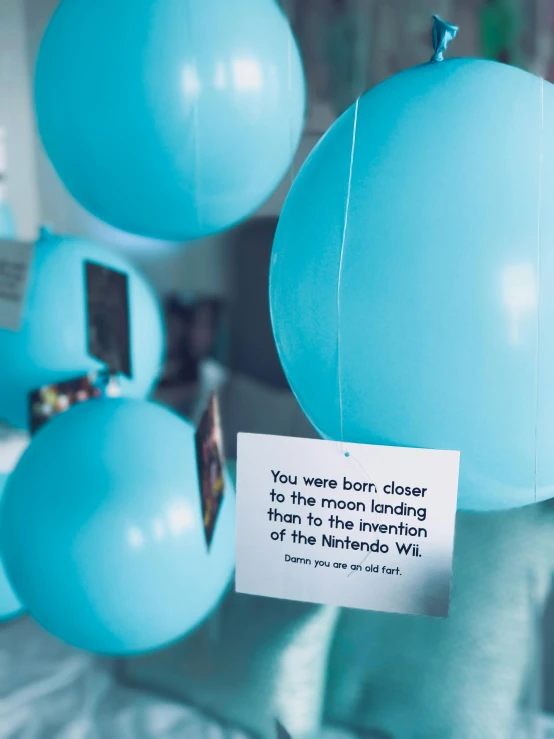a bunch of blue balloons sitting on top of a bed, a polaroid photo, happening, hero world nintendo, gallery display photograph, close-up shot taken from behind, an escape room in a small