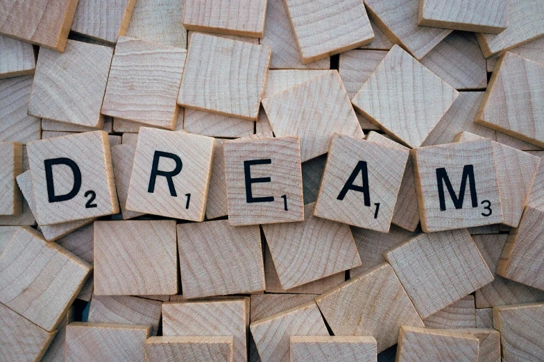 a pile of scrabbles with the word dream written on them, unsplash, cream, 🚿🗝📝, squares, dreams are like poetry