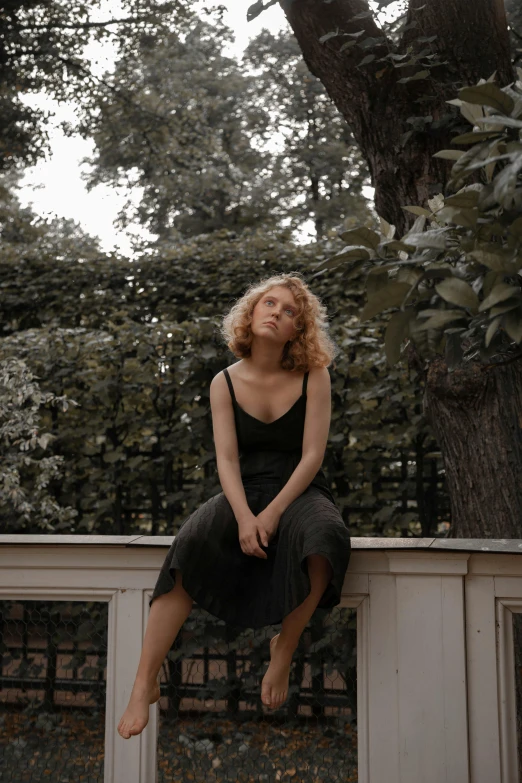 a woman in a black dress sitting on a fence, by Caro Niederer, pexels contest winner, renaissance, short curly blonde haired girl, wearing a tanktop and skirt, with a french garden, julia gorokhova