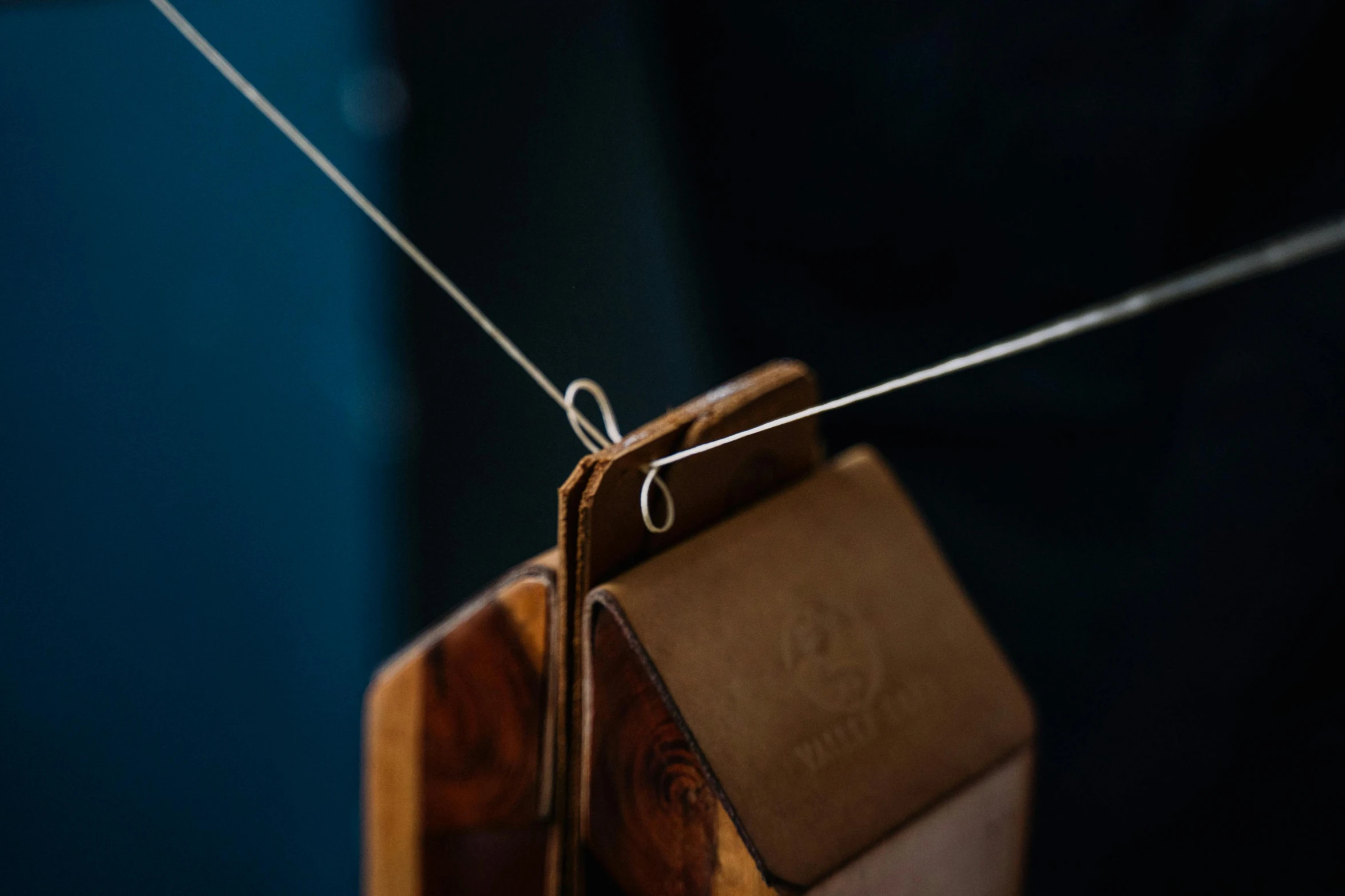 a close up of a pair of scissors on a string, by Jessie Algie, holding a wood piece, spitfire, currents, ignant