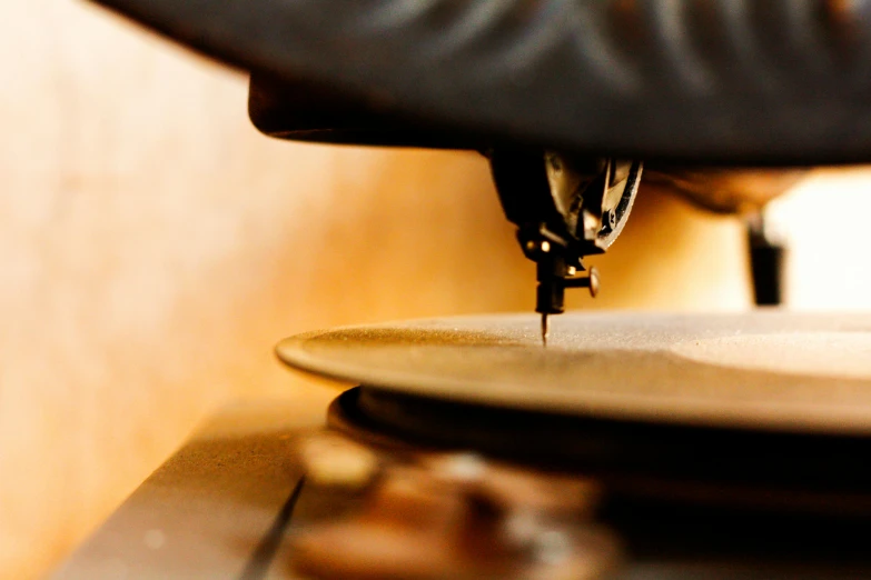 a close up of a plate on a table, an album cover, unsplash, private press, intricate machinery, music being played, thumbnail, lathe