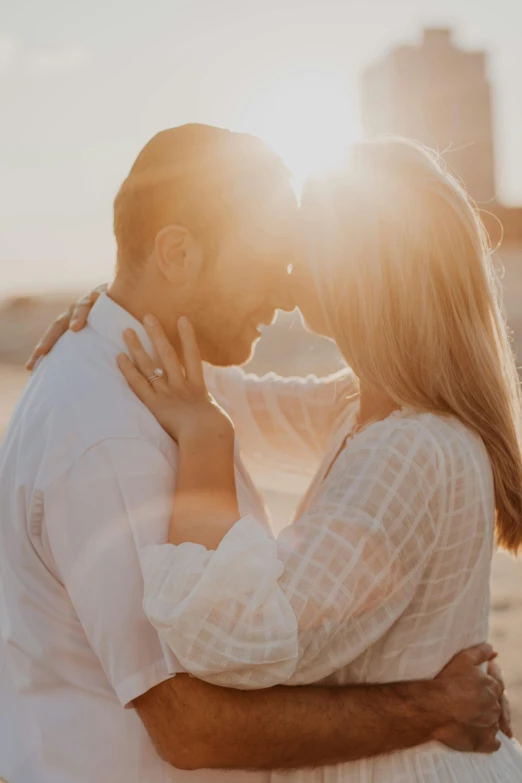 a man and a woman kissing on the beach, pexels contest winner, delicate soft hazy lighting, bright sunlight, engagement ring ads, video