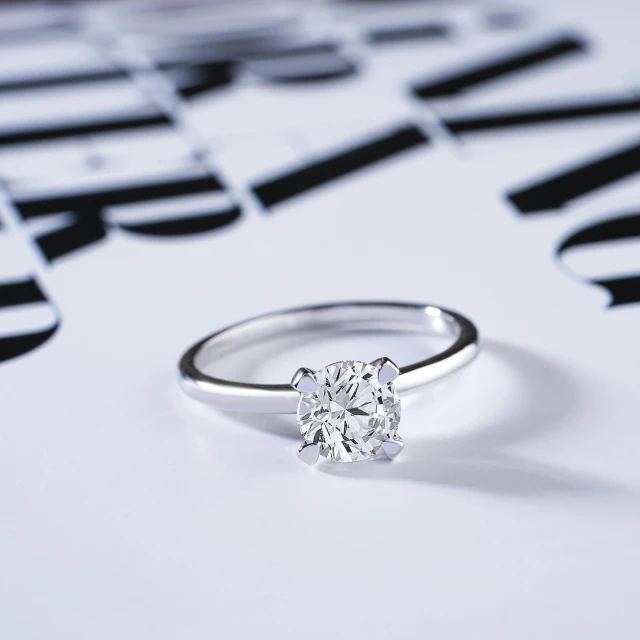 a diamond ring sitting on top of a piece of paper, shutterstock contest winner, photorealism, top down shot, on display, poster shot, silver accessories