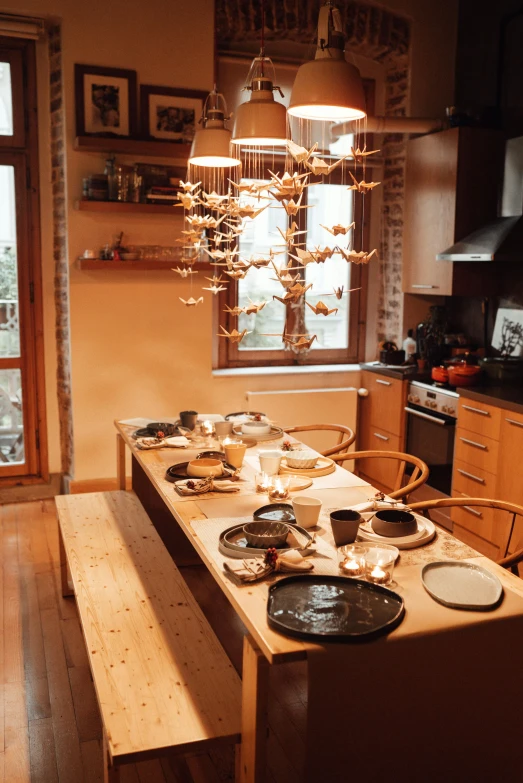 a dining room filled with lots of wooden furniture, by Niyazi Selimoglu, handmade pottery, chef table, hygge, raku