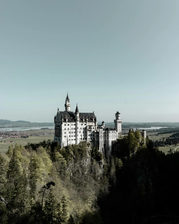 a castle sitting on top of a lush green hillside, pexels contest winner, german romanticism, grey, gif, munich, set photo
