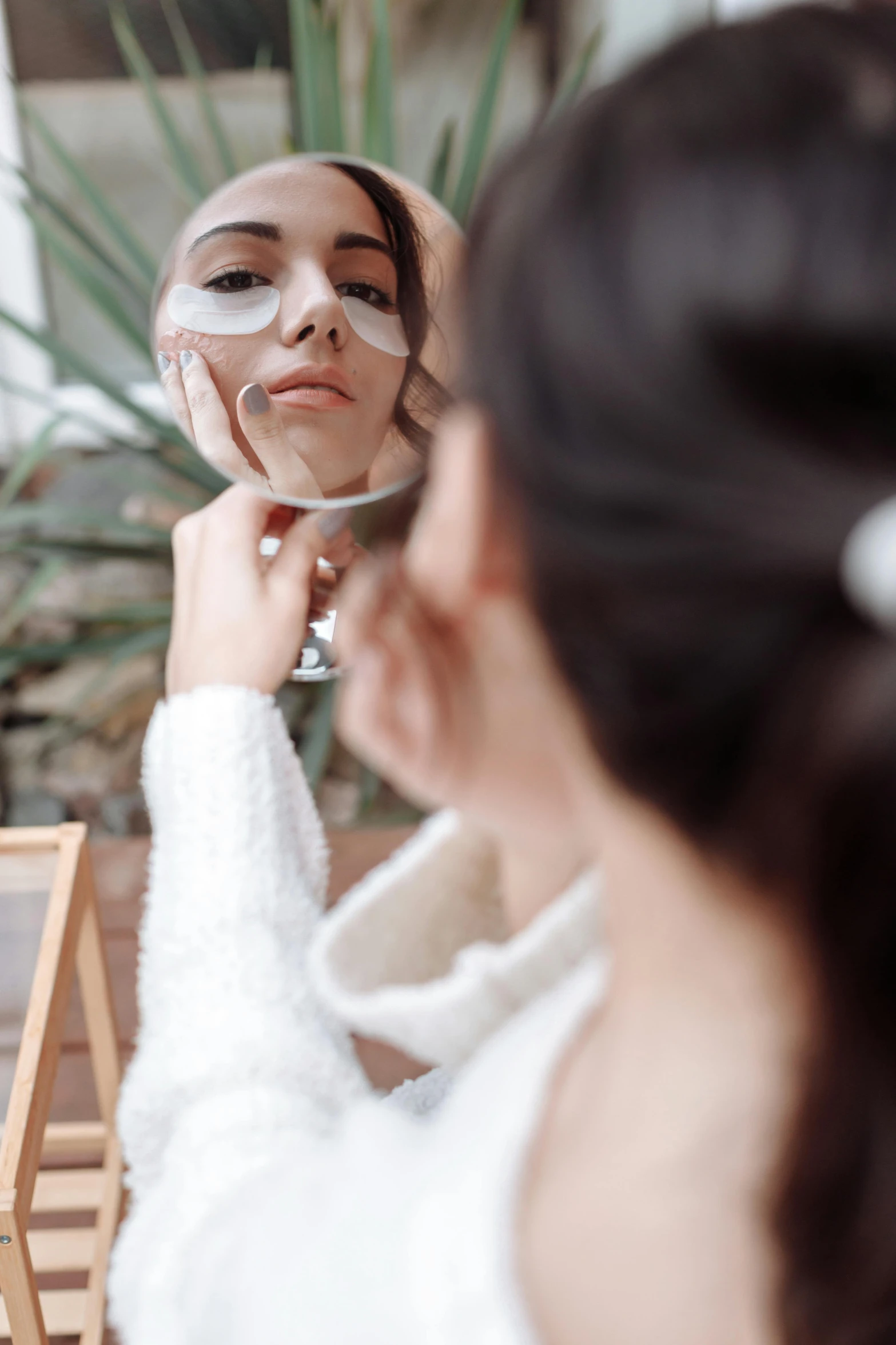 a woman that is standing in front of a mirror, black eye patch over left eye, photoshoot for skincare brand, robe. perfect faces, clear reflection