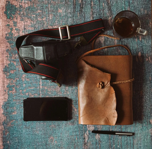 a purse sitting on top of a table next to a cell phone, a still life, trending on pexels, renaissance, wide belt scabbard, portrait of an adventurer, a high angle shot, thumbnail