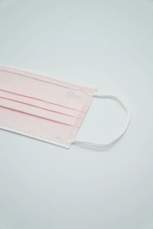 a pink face mask on a white plate, unsplash, surgical supplies, detailed product image, low detail, rectangle