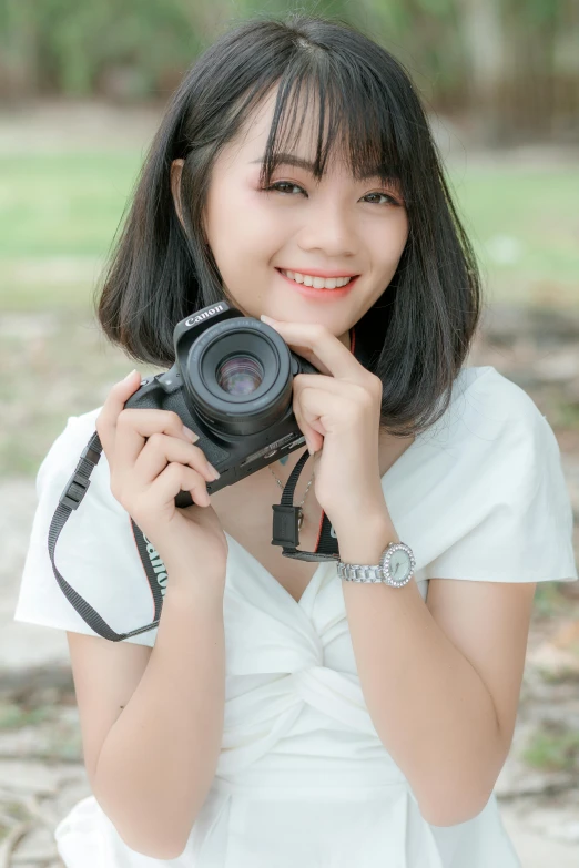 a woman holding a camera in front of her face, anime thai girl, 5 0 0 px models, while smiling for a photograph, plain