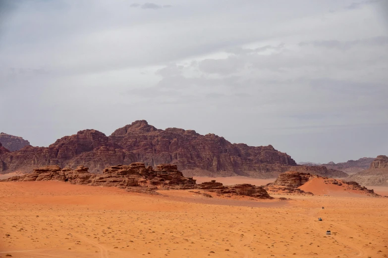 a person riding a horse in the desert, pexels contest winner, hurufiyya, an island made of red caviar, geological strata, seen from afar, 2 0 0 mm wide shot