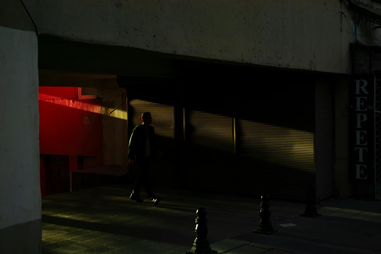 a person walking down a sidewalk next to a fire hydrant, inspired by Elsa Bleda, red neon, ignant, shaded lighting, by emmanuel lubezki