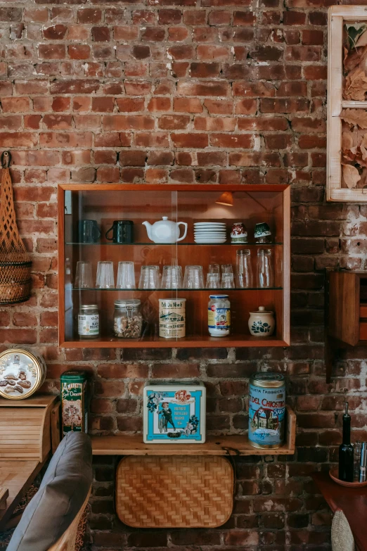 a living room filled with furniture and a brick wall, pexels contest winner, maximalism, jar on a shelf, cute kitchen, brown, display case