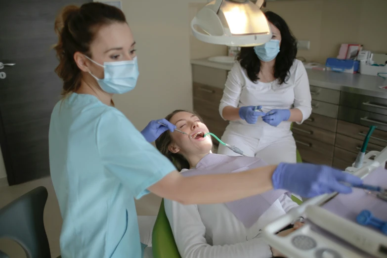 a woman getting her teeth examined by a dentist, pexels contest winner, hurufiyya, avatar image, group photo, thumbnail, white