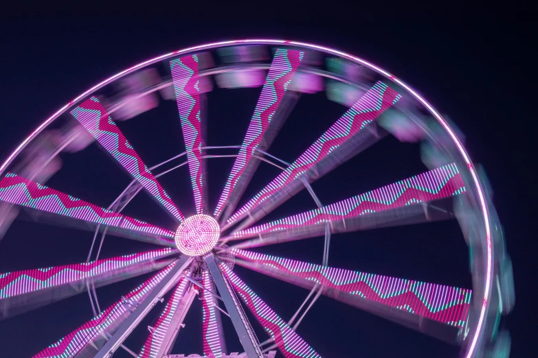 a ferris wheel is lit up at night, a portrait, pexels contest winner, kinetic art, crown of (pink lasers), wheels, zig zag, cotton candy