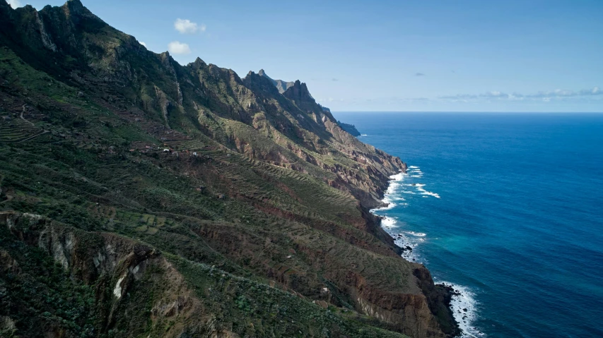 a view of the ocean from the top of a mountain, by Daniel Lieske, pexels contest winner, les nabis, view from helicopter, brown, thumbnail, piroca